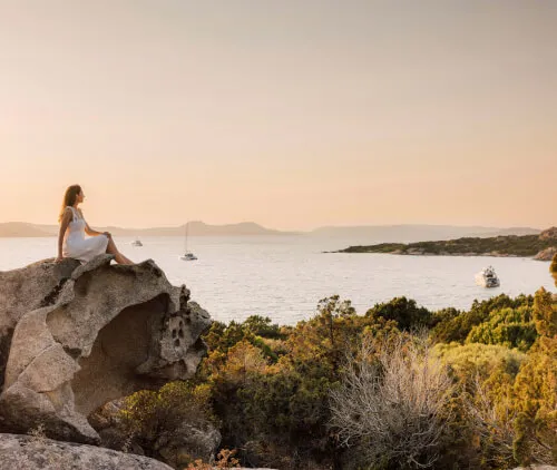 Woman enjoying a serene view at 7Pines Resort Ibiza, embracing nature's beauty.